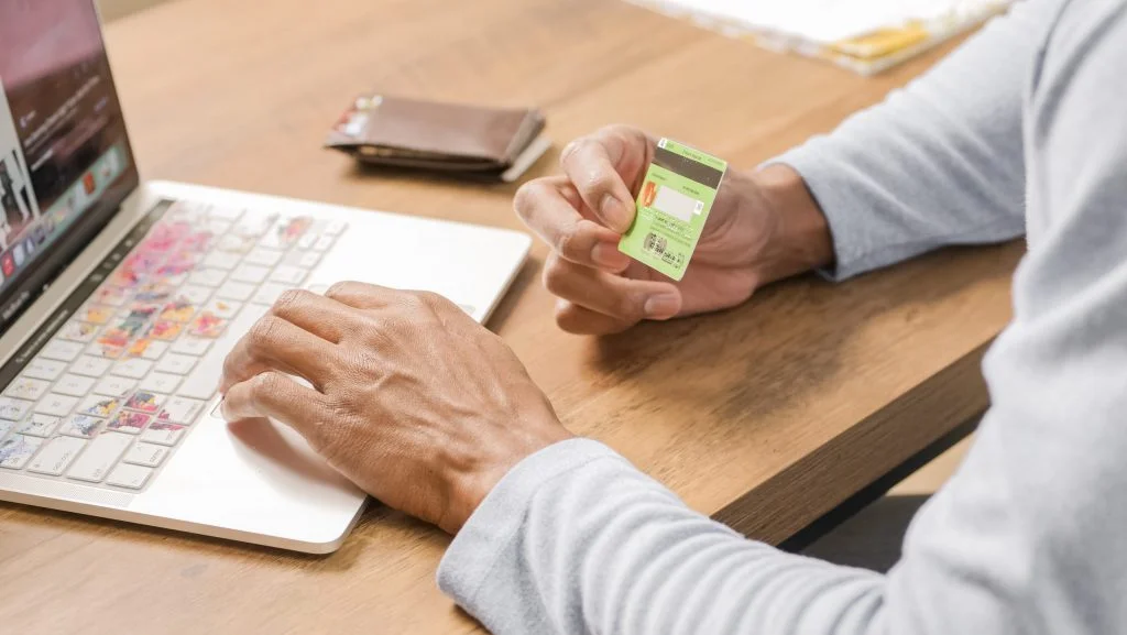 A man with laptop and visa credit card paying for digital services